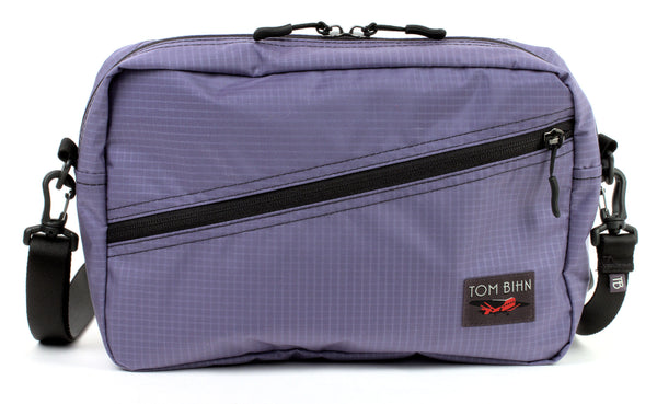 A Packing Cube Shoulder Bag in Dusk (blue-grey with light blue-grey grid) 210 Cerylon with a shoulder strap attached